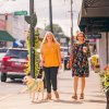 Two women walking down sidewalk in downtown Mount Airy