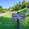 Sign reading "Forrest Gump ran this curve" next to road curving uphill