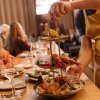 Waiter placing hree-tier seafood tower on table for diners