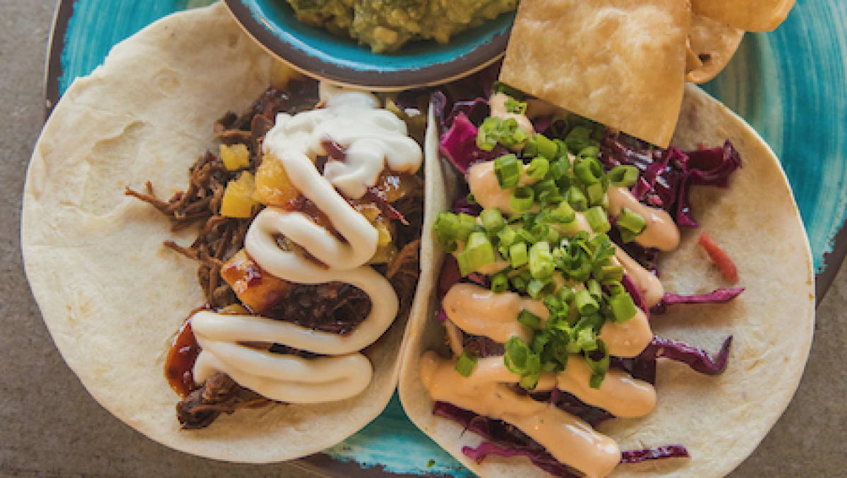 Two tacos side by side on a plate