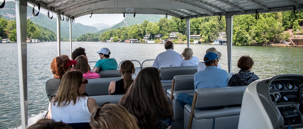 People on boat taking a Lake Lure Boat Tour during daytime