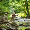 Two men fly fishing at Chetola Resort in Blowing Rock during summer