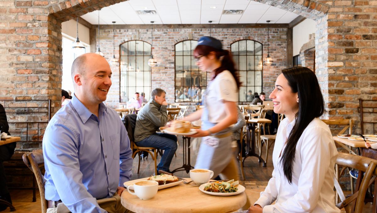 Couple smiling at each other while dining at La Farm Bakery 