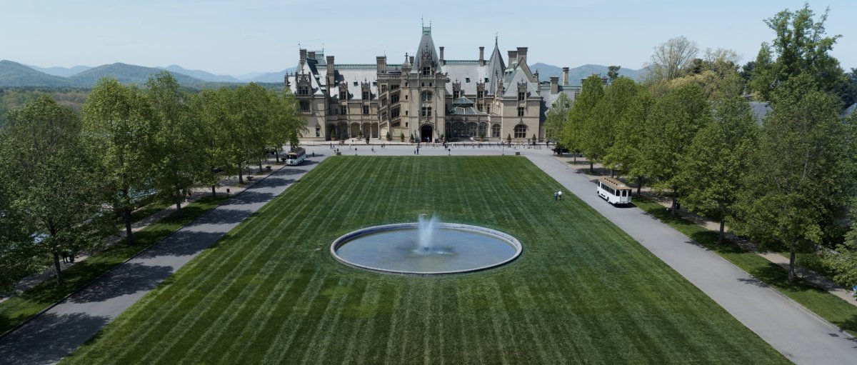 Vast, empty grounds of Biltmore with estate and mountains in back