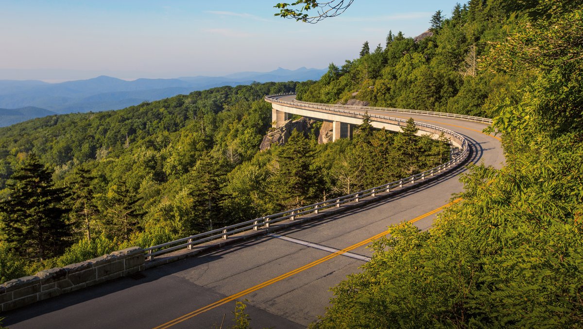 Linn Cove Viaduct on Blue Ridge Parkway with mountains in distance