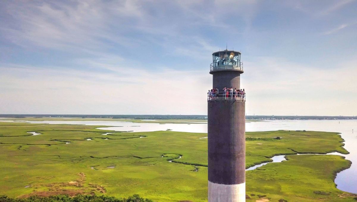 People at the top of Oak Island Lighthouse with marshes in background in Brunswick Islands