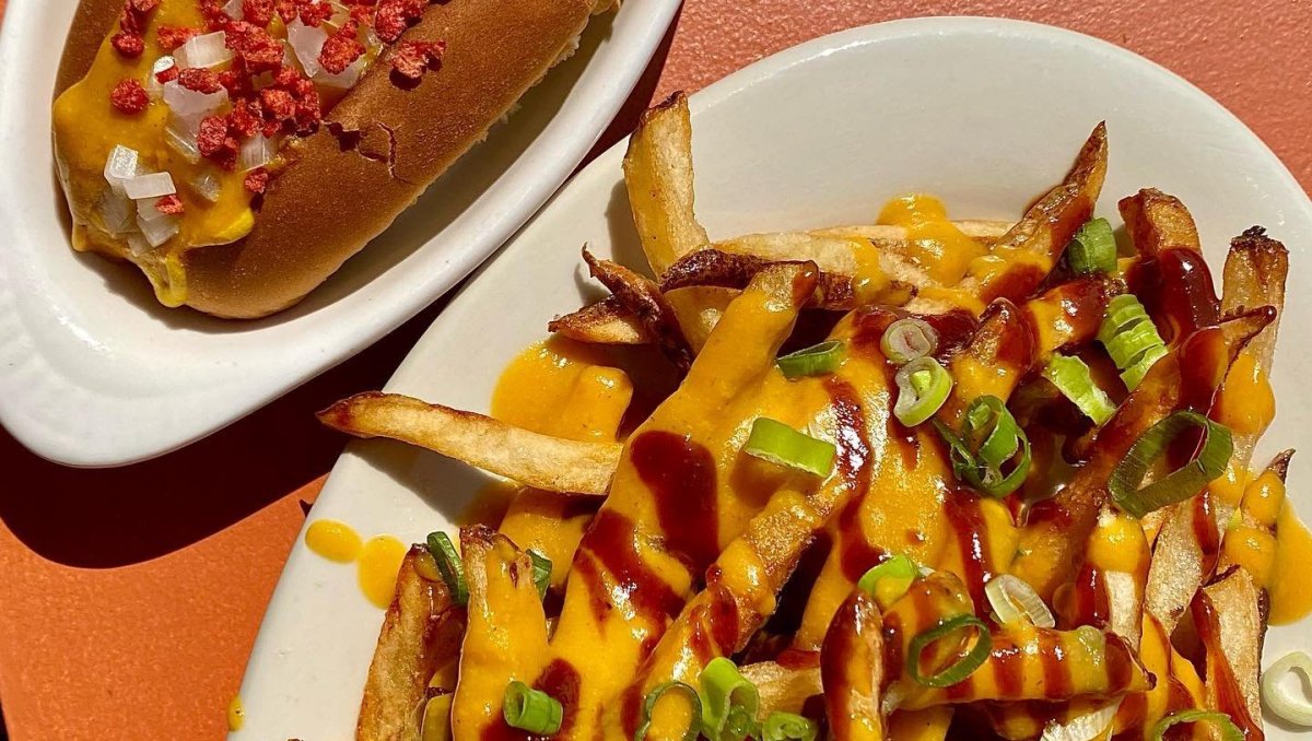 Closeup, overhead shot of plated vegan fries and vegan hot dog