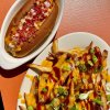 Closeup, overhead shot of plated vegan fries and vegan hot dog