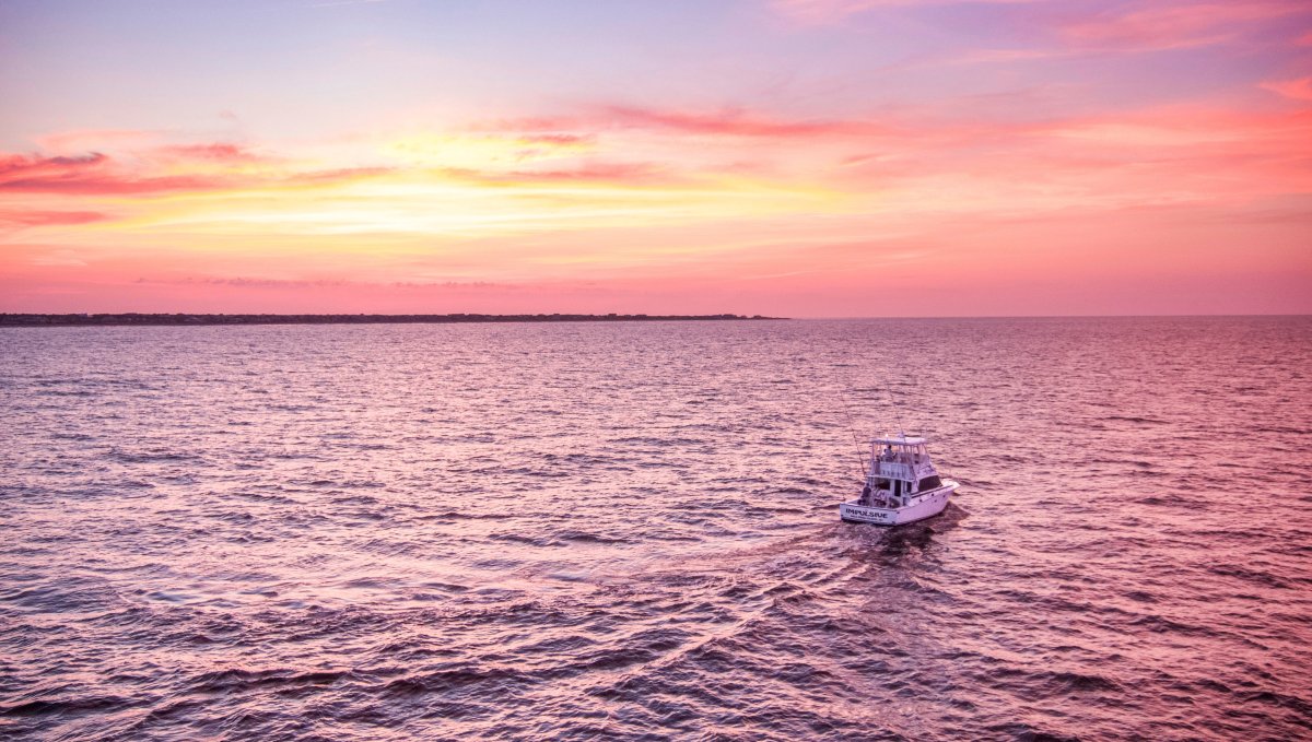 Fishing Road On Charter Fishing Boat Against Pink Sunrise Sky On