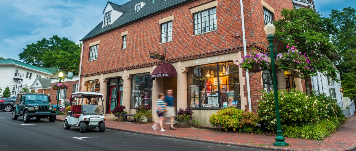 Brick gallery on a street in Village of Pinehurst with golf cart parked out front