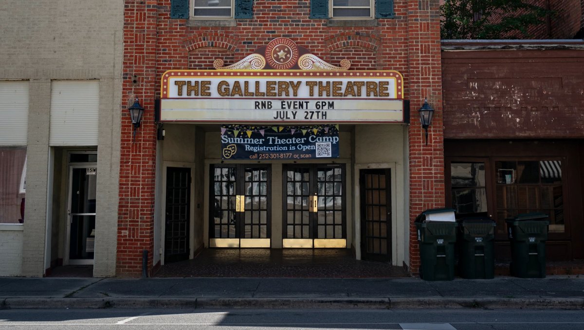 Exterior of local brick theater with marquee reading 