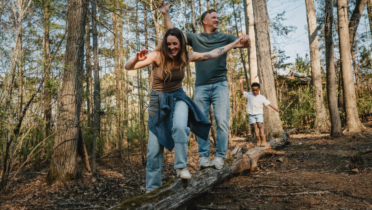 Family hiking through trails at Daniel Stowe Conservancy.