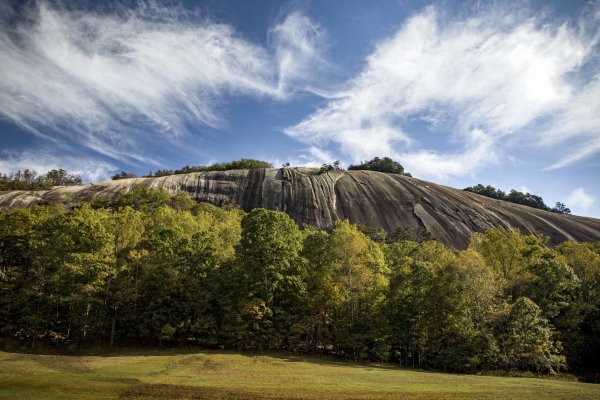 Stone mountain rising up over fall foliage at Stone Mountain State Park.