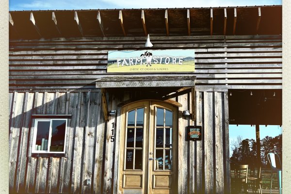 Exterior of farm store with signage above door during daytime