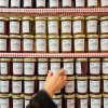 Person at Mast General Store in Valle Crucis reaching for jar of jelly.