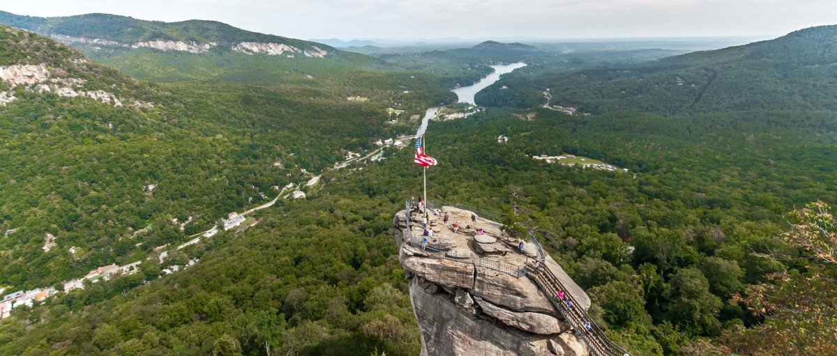 Aerial view of Chimney Rock with river and valley in background on cloudy day