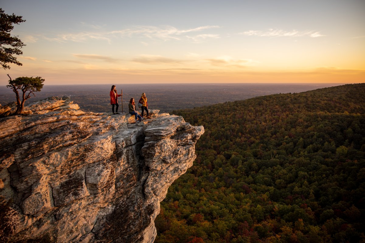 three people at an overlook in Hanging Rock State Park