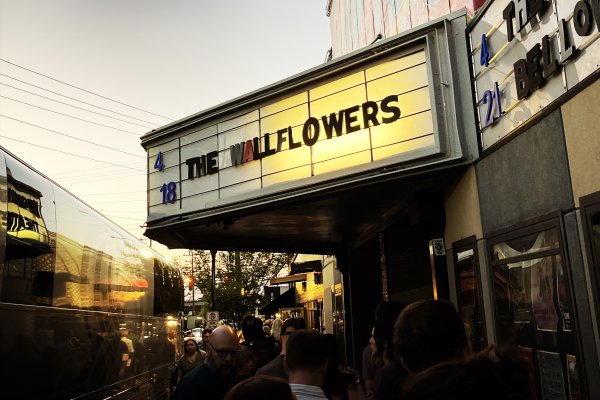 Side view of marquee reading "The Wallflowers" at music venue at dusk 