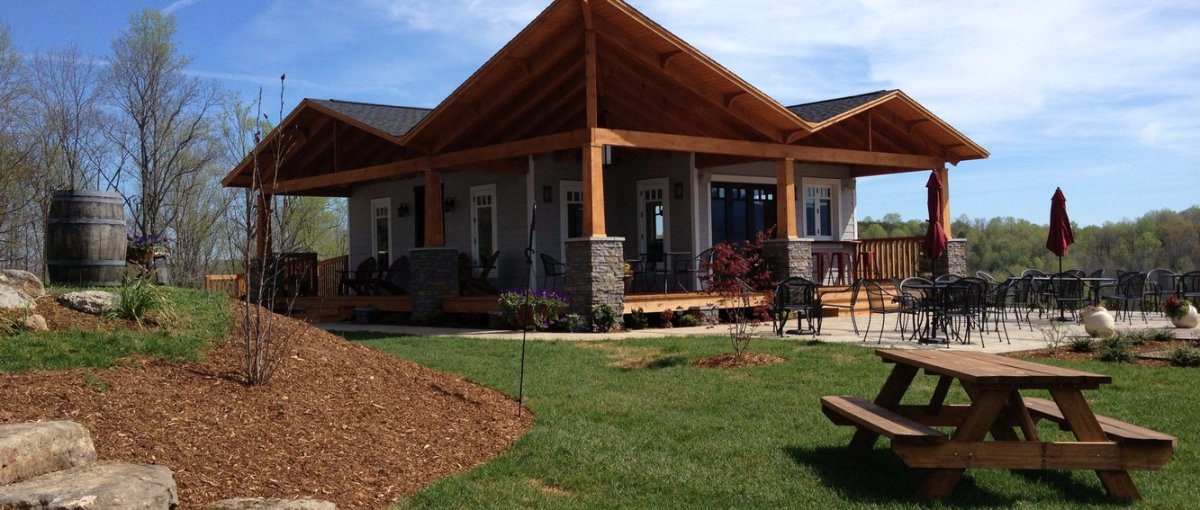 Exterior view of Silver Fork Winery on sunny day with empty patio and lawn in foreground