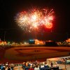 Fireworks over baseball field with fans sitting in stands admiring the show
