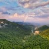 Long-range mountain views with rainbow in the sky.