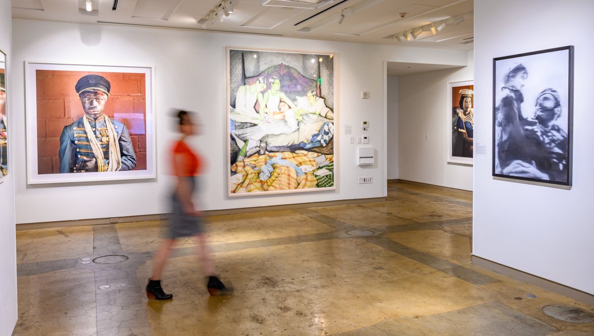 Out-of-focus woman walking through art gallery