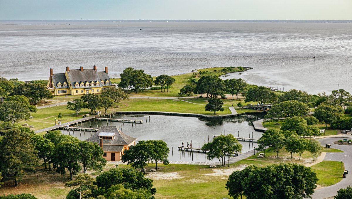 Aerial of historic waterfront mansion with expansive grounds