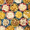 Overhead shot of little bowls of different flavored Poppy popcorn.