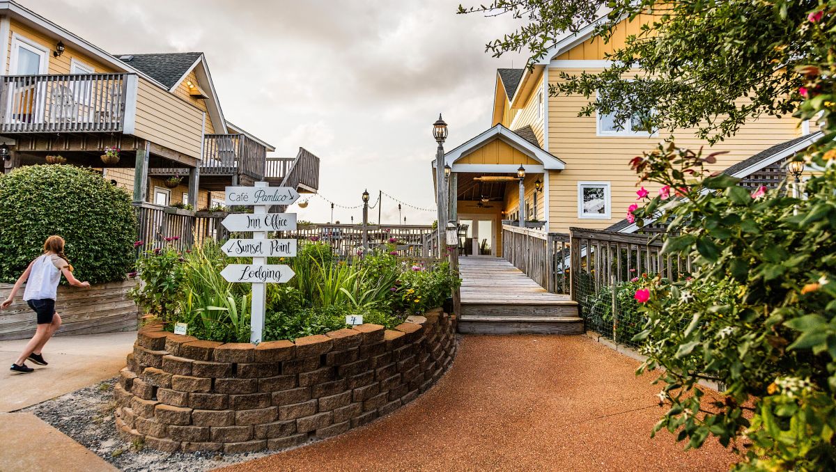 Exterior of the Inn on Pamlico Sound with child walking on walkway during daytime