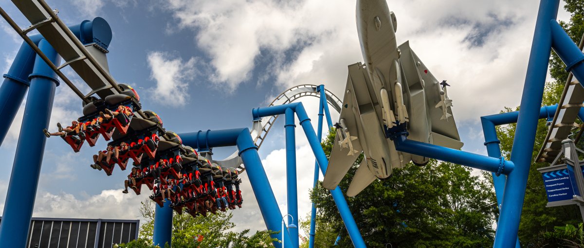 Large blue roller coaster with spaceship at Carowinds amusement park outside.