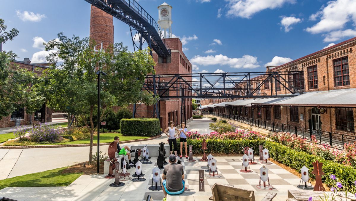 People exploring American Tobacco Campus on bright sunny, day in Durham