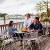Couple eating on waterfront patio at Ghost Harbor Brewing