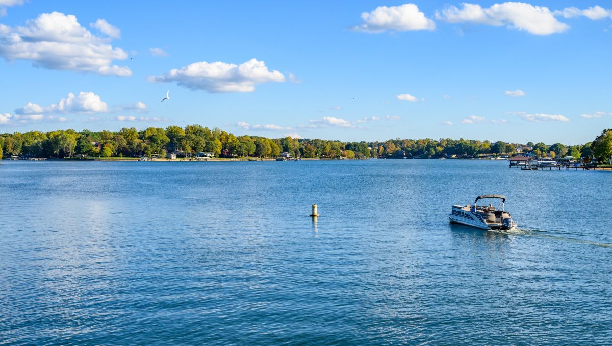 Pontoon boat on empty Lake Norman during bright, sunny day