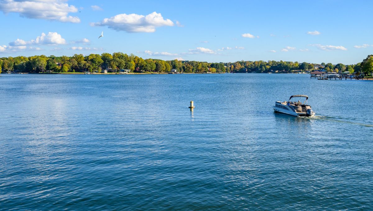 Pontoon boat on empty Lake Norman during bright, sunny day