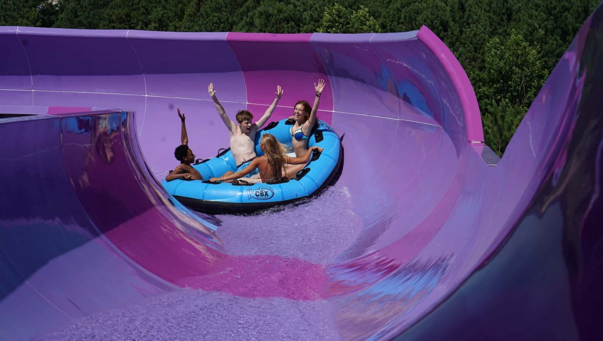 Friends going down waterslide on an intertube at H2OBX