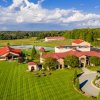 Aerial of beautiful winery grounds and vineyards during sunny day
