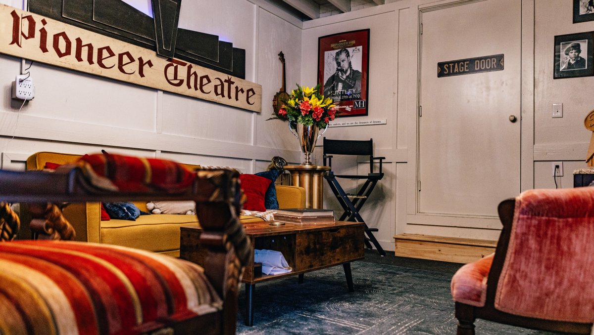 Interior of old theater with plush seating and theater signage