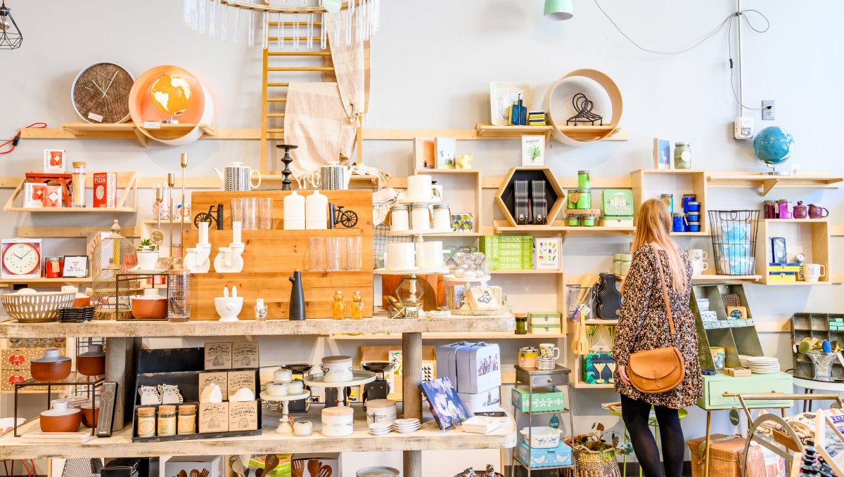 Woman browsing interior displays at DECO Raleigh shop.