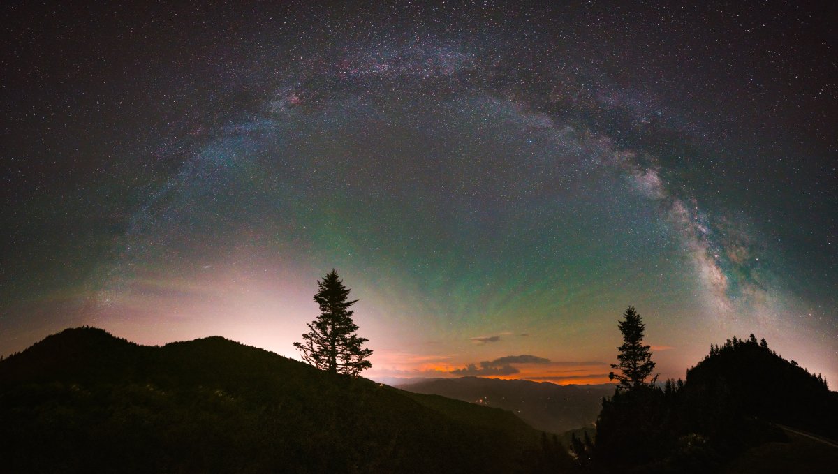 Starry night above mountains.