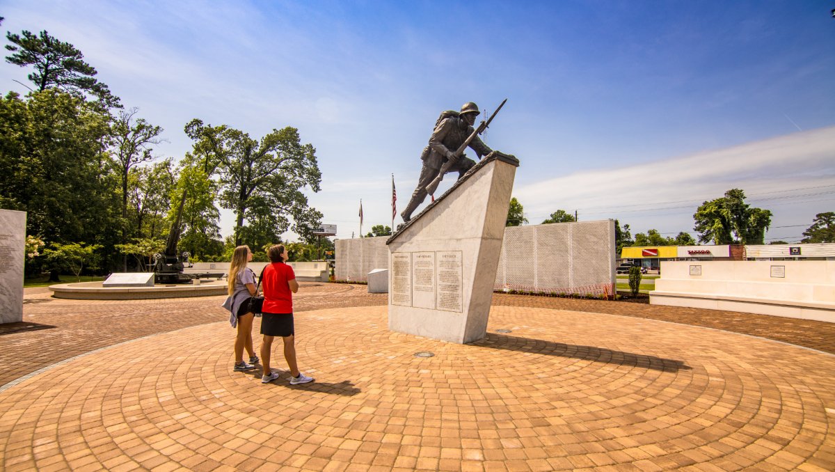 Two people observing memorial in outdoor gardens