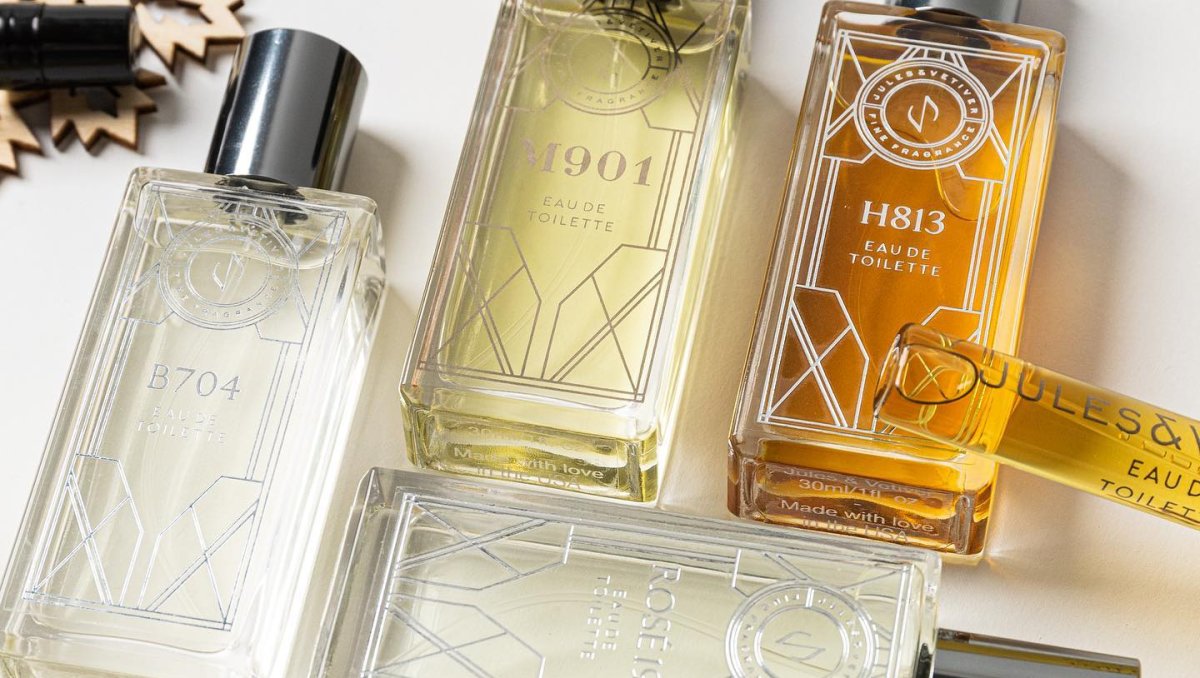 Closeup of perfumes laid on table on display.