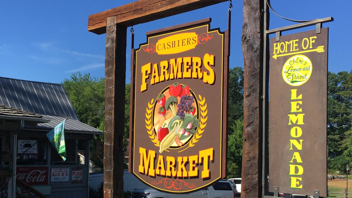 Farmer's Market sign outside building during daytime.