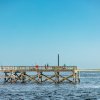 Anglers fishing from town fishing pier that extends into the Cape Fear River