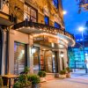 Exterior of The Dunhill hotel in Charlotte with lit marquee at dusk