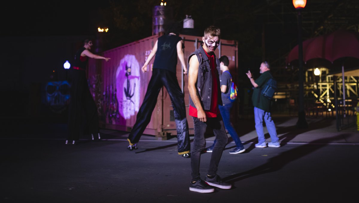 Person with creepy face paint walking at Halloween event at Carowinds.