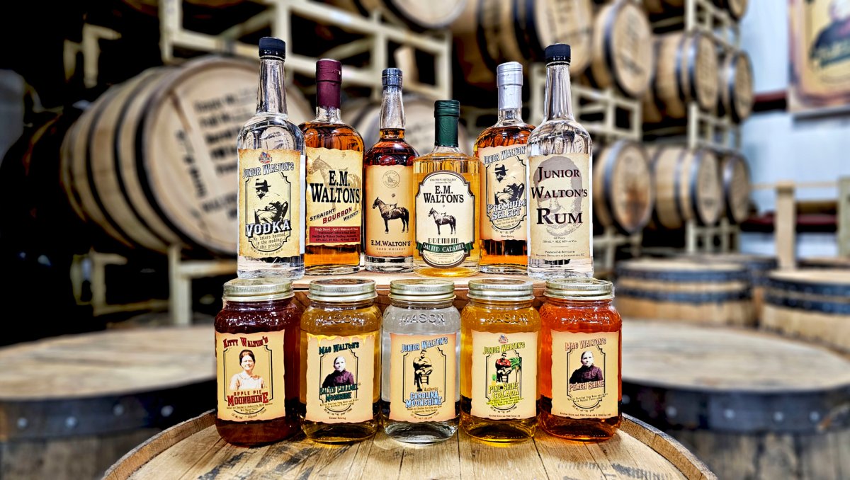 Bottles of spirits posed on top of barrel in warehouse