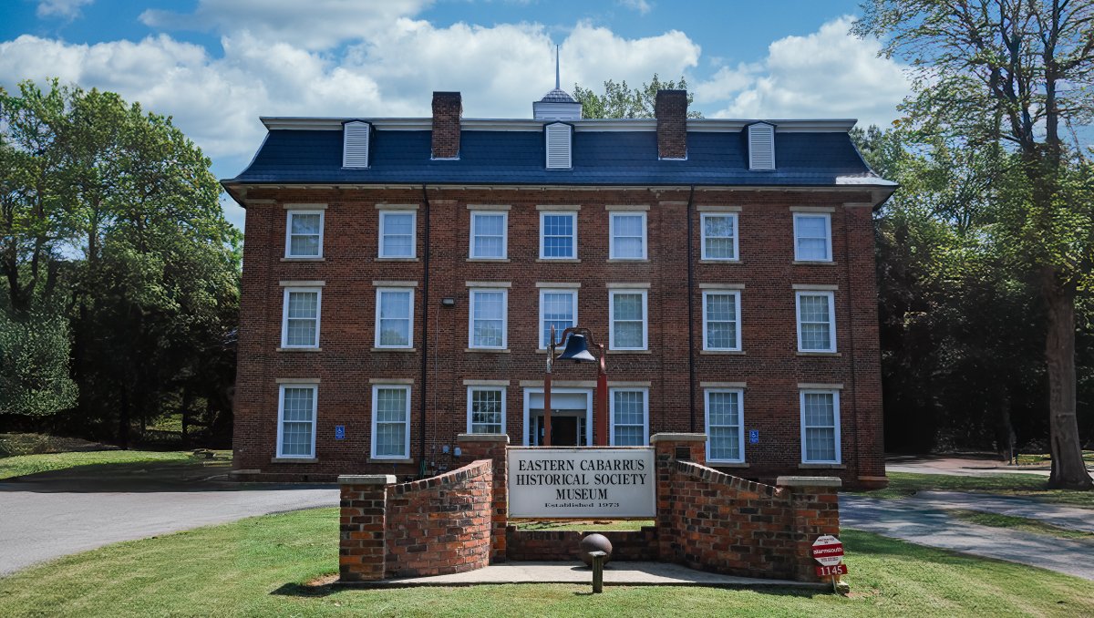 Exterior brick building of Eastern Cabarrus Historical Society Museum during daytime.