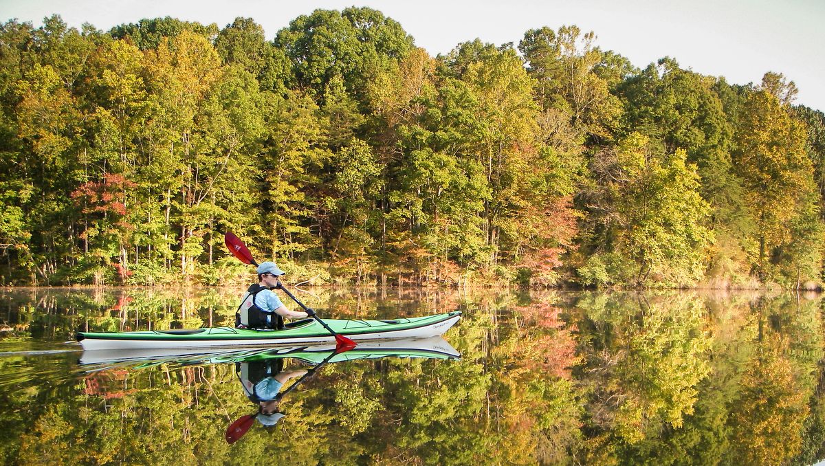 a person paddling a kayak at Salem Lake in Winston-Salem