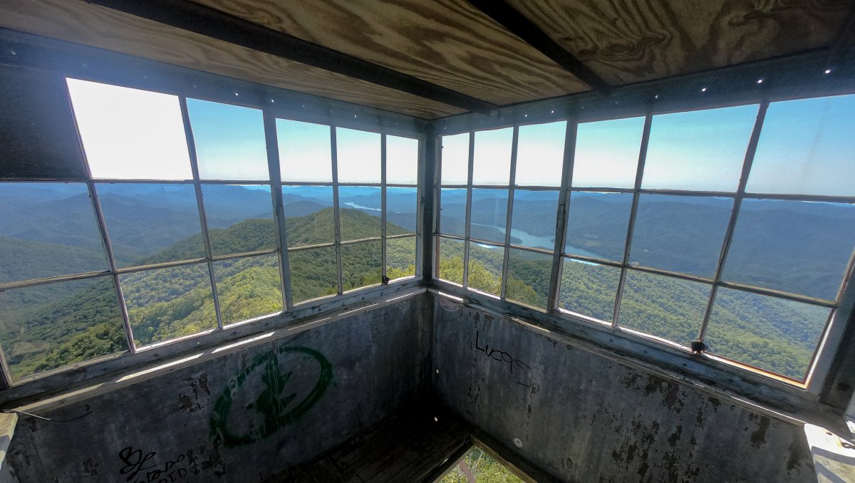 Wide-range views of mountains and lake out of Shuckstack Tower windows.