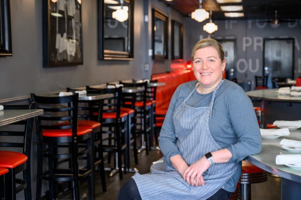 Chef Ashley Christensen sits at a countertop smiling